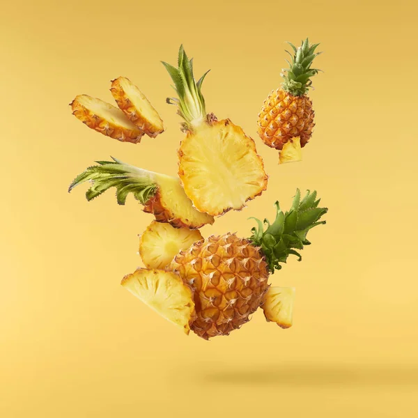 Flying in air fresh ripe whole and cut baby Pineapple with slice — Stock Photo, Image