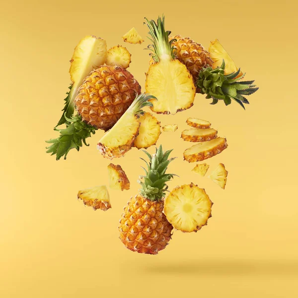 Flying in air fresh ripe whole and cut baby Pineapple with slice — Stock Photo, Image