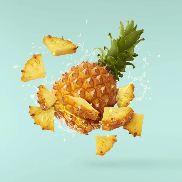 Flying in air fresh ripe whole and cut baby Pineapple with slice — Stock Photo, Image