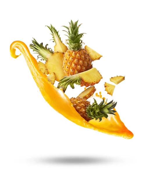 Flying in air fresh ripe whole and cut baby Pineapple with slice