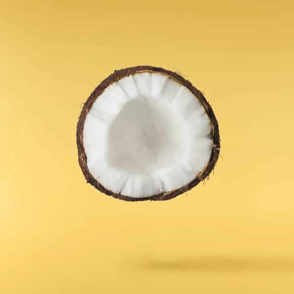 Fresh ripe coconut isolated on yellow background — Stock Photo, Image