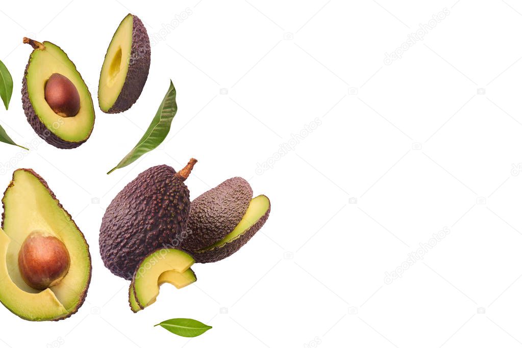 Fresh ripe avocado with leaves falling in the air. 