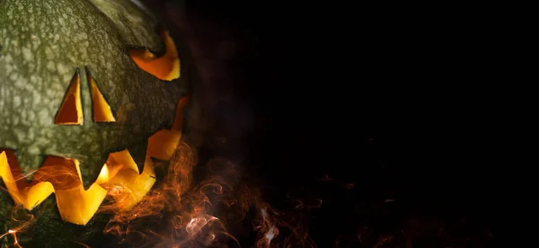 Halloween background. Spooky pumpkin glow in the dark. Halloween design with copyspace