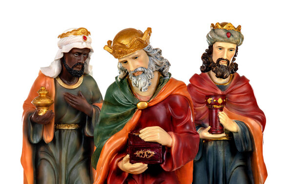 The three wise men and baby Jesus. Ceramic figures isolated on white background