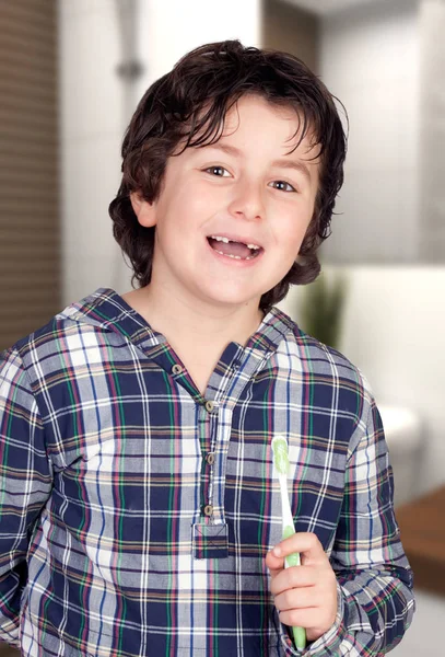 バスルームで彼の歯を磨くいくつかの歯のない面白い子供 — ストック写真