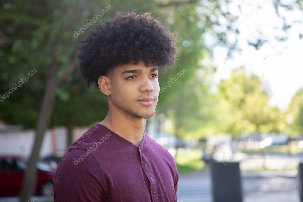 male teenager with afro hairstyle on the street