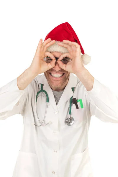 白い背景に隔離されたクリスマス帽子を身に着けているクリスマス帽子を持つハンサムな医者 — ストック写真