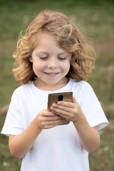 公園で携帯電話を保持している長い髪を持つ面白い子供 — ストック写真