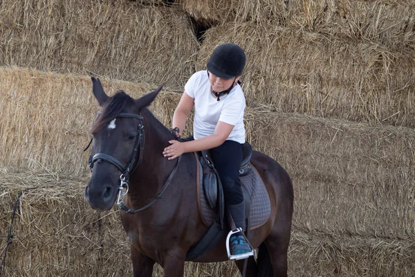 Learning to ride in the riding school