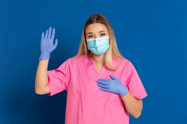 Young Doctor Wearing Mask Face Pink Uniform Blue Background — Stock Photo, Image