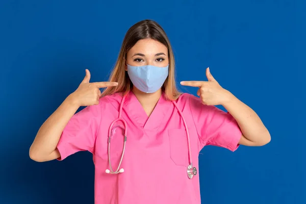 Young Doctor Wearing Mask Face Pink Uniform Blue Background — Stock Photo, Image