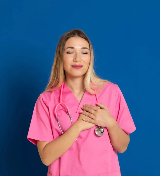 Blonde doctor with pink uniform on a blue background