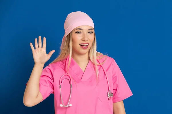 Ung Läkare Med Rosa Uniform Och Halsduk Blå Bakgrund — Stockfoto