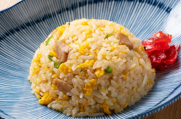 Kızarmış pirinci mavi bir tabakta yakın.