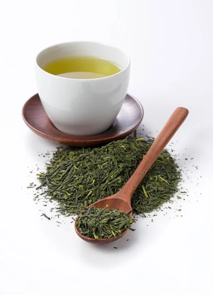 Green tea and tea leaves on a white background. Image of Japanese green tea