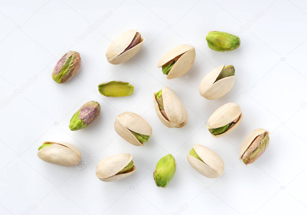 A bird's-eye view of pistachios on a white background