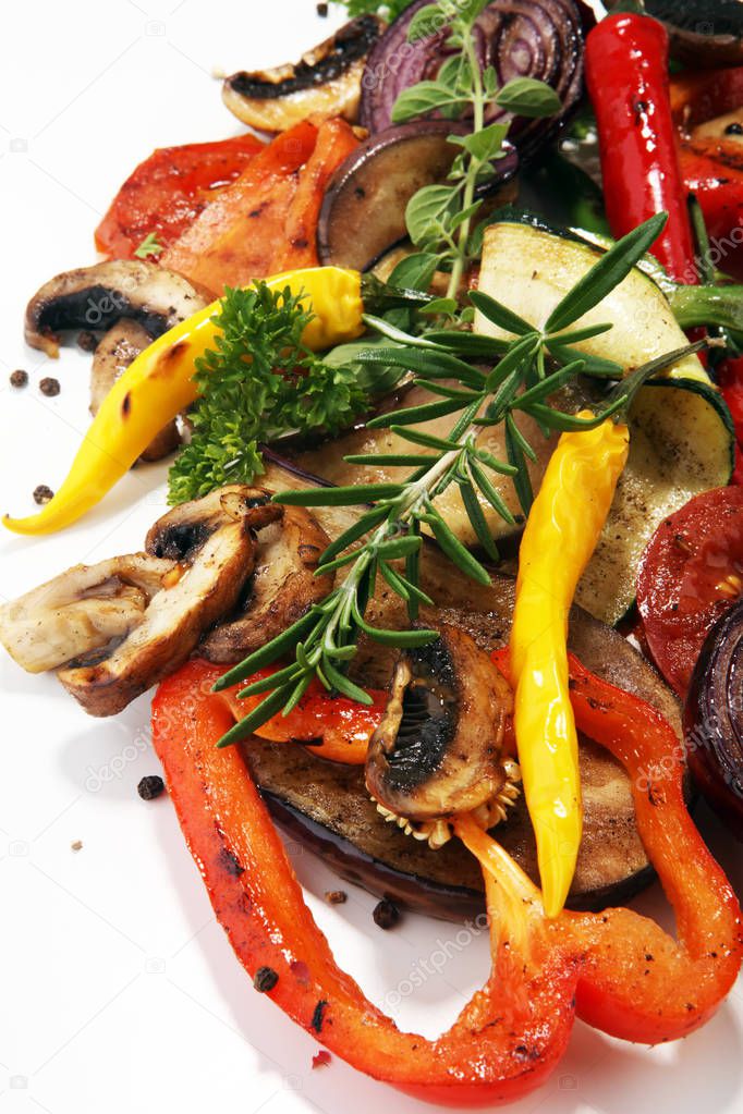 Grilled vegetables. Tomatoes, zucchini, bell pepper and fresh herbs. Vegan grill concept.