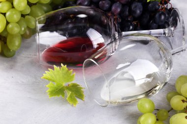 Kırmızı şarap ve beyaz şarap üzüm ve rustik zemin üzerine gözlük ile