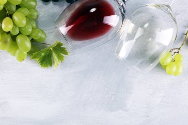 Kırmızı şarap ve beyaz şarap üzüm ve rustik zemin üzerine gözlük ile