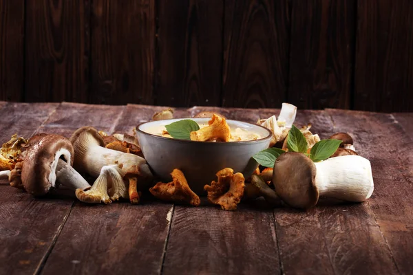 Mushroom soup and variety of raw mushrooms on wooden table. oyster and other fresh mushrooms — Stock Image Mushroom Soup Variety Raw Mushrooms Wooden Table Oyster Other Fresh Royalty Free Stock Images