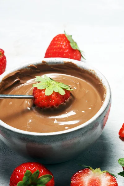 Fondue with Melting chocolate or melted chocolate and strawberry