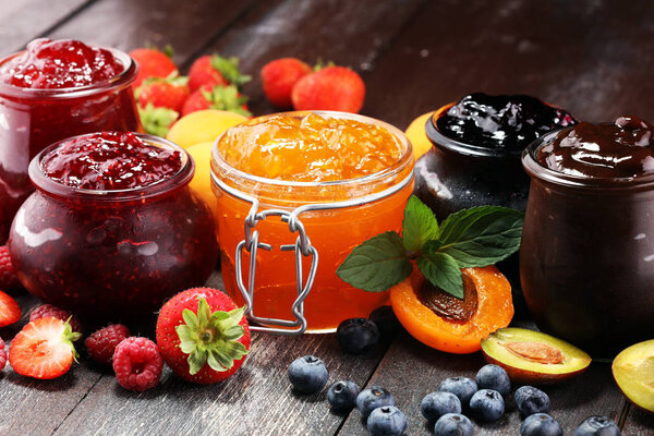 assortment of jams, seasonal berries, apricot, mint and fruits. marmalade or confiture
