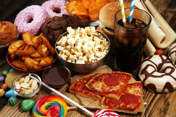 Unhealthy products. food bad for figure, skin, heart and teeth. Assortment of fast carbohydrates food. American unhealthy food.