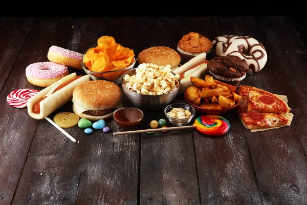 Unhealthy products. food bad for figure, skin, heart and teeth. Assortment of fast carbohydrates food. American unhealthy food.