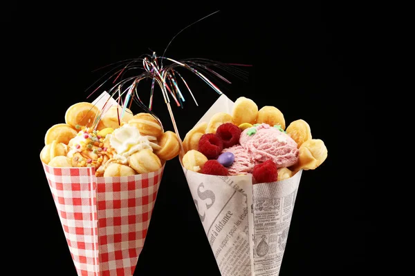 Hong Kong style egg waffle. bubble waffle with sundae ice cream and fruits. street food waffles