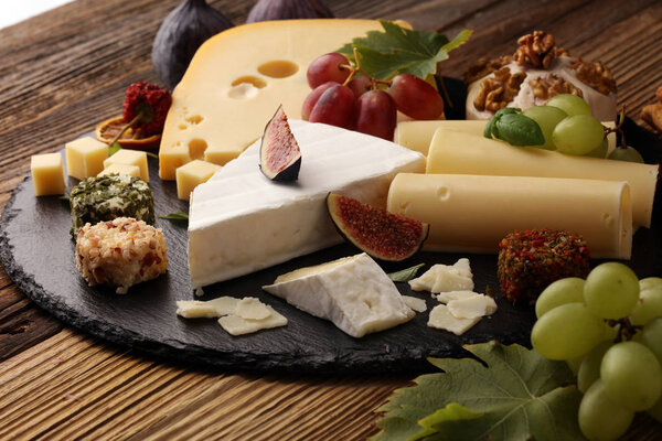 Cheese platter with different cheese and grapes
