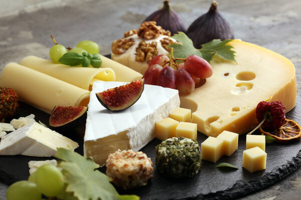 Cheese platter with different cheese and grapes