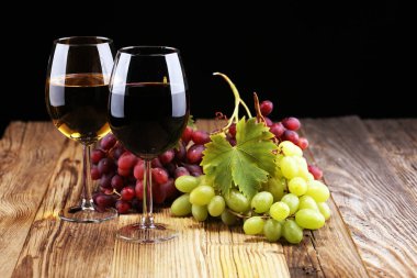 Beyaz şarap ve kırmızı şarap bir bardak ile sonbahar üzüm rustik arka plan üzerinde