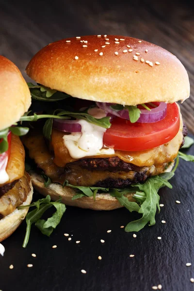 Tasty fresh meat burgers with salad and cheese. Homemade angus burger