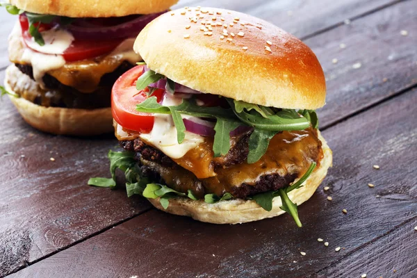 Tasty fresh meat burgers with salad and cheese. Homemade angus burger