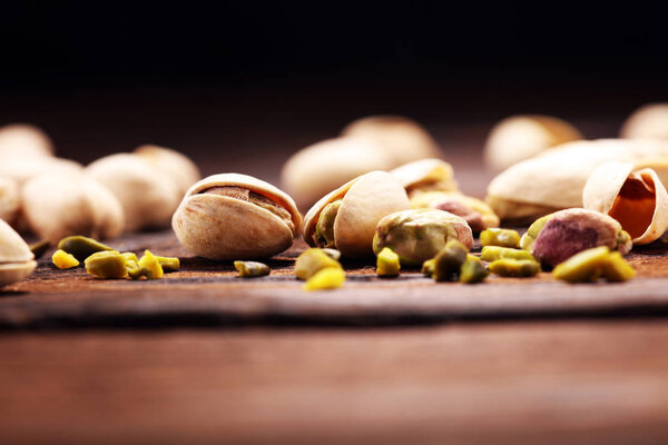Pistachios, Roasted pistachio seeds in shells and shelled. Green, dried fruits, whole and chopped. 
