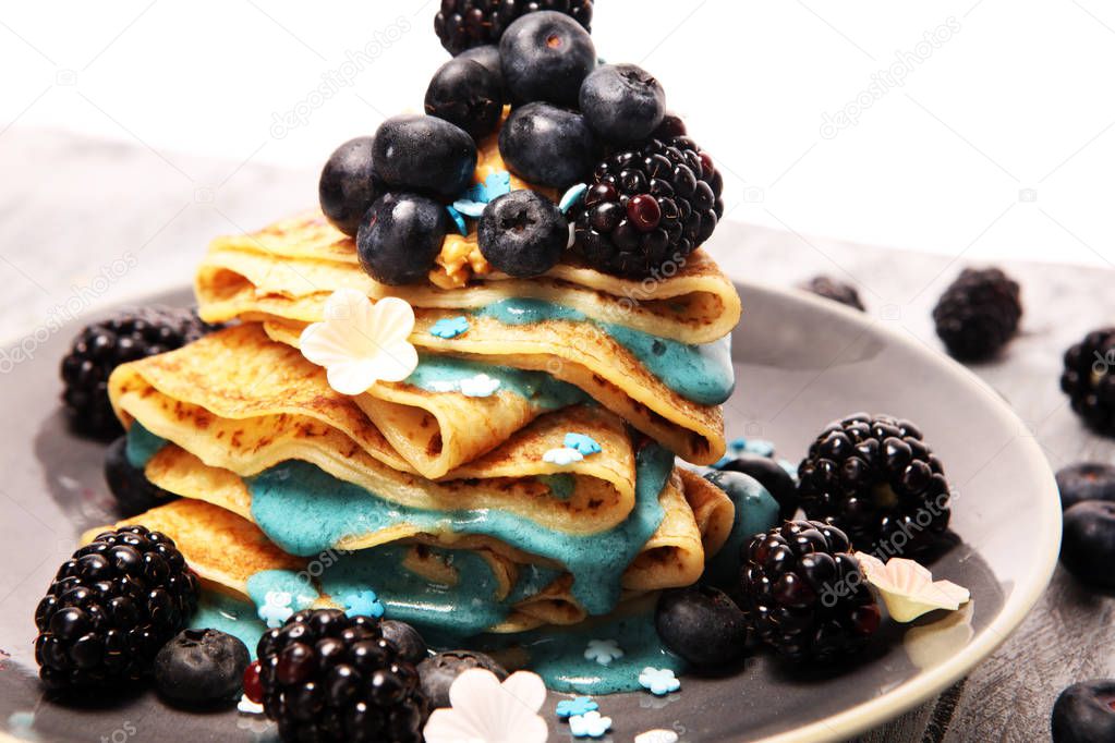 Delicious Tasty Homemade crepes or pancakes with blackberries,blueberries and blue spirulina nicecream