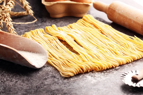 pasta. Fresh homemade pasta with pasta ingredients on the rustic table