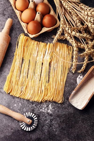 pasta. Fresh homemade pasta with pasta ingredients on the rustic table