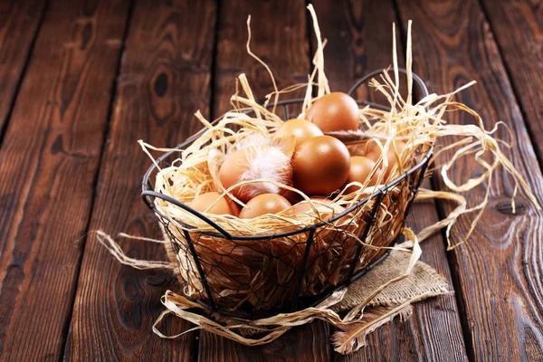 Egg. Fresh farm eggs in basket. Easter egg with feather concept