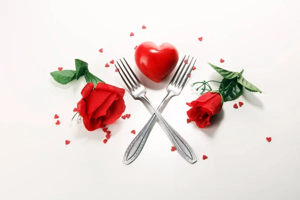 Festive table setting for Valentine\'s Day with forks and hearts