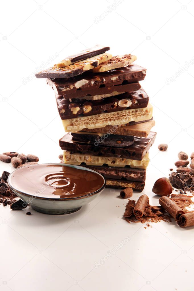 Chocolate bars on table with chocolate tower. Chocolate and nuts and choco swirl