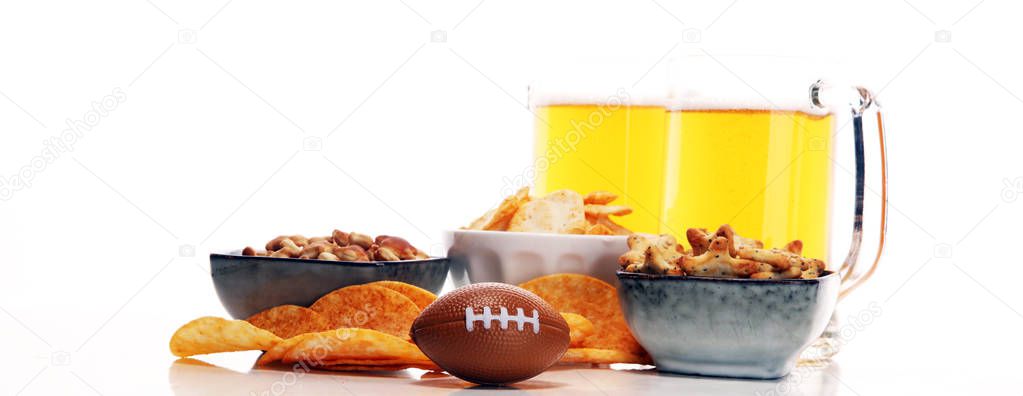 Chips, salty snacks, football and Beer on a table. Great for Bowl Game projects.