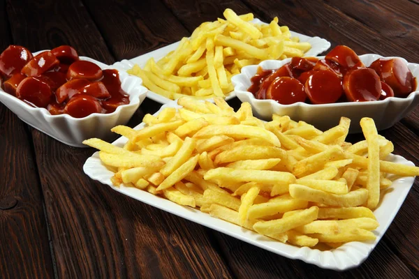 currywurst with fries. traditional german food with sausages and curry and fries