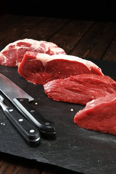 Steak raw. Barbecue Rib Eye Steak, dry Aged Wagyu Entrecote. Variety of Raw Black Angus Prime meat steaks Machete, Striploin, Rib eye, Tenderloin fillet mignon