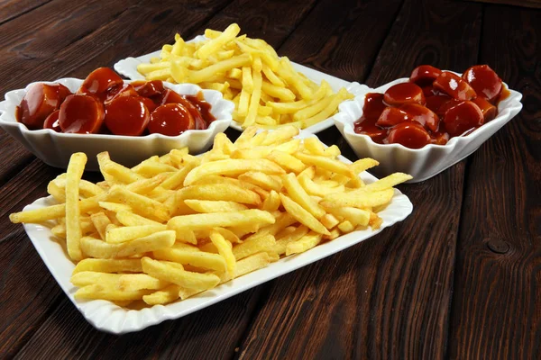 currywurst with fries. traditional german food with sausages and curry and fries