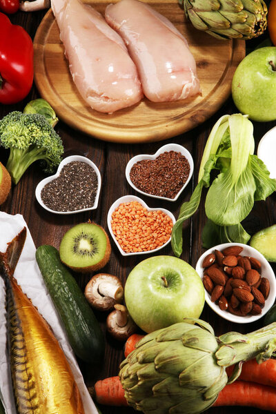 Healthy food clean eating selection. fruit, vegetable, seeds, superfood, cereals, leaf vegetable and fish and chicken.