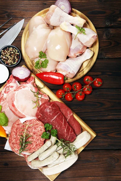 raw meat. Different types of raw pork meat, chicken and beef with spices and herbs and sausages