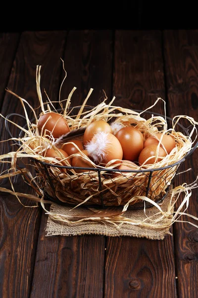 Egg. Fresh farm eggs in basket. Easter egg with feather concept