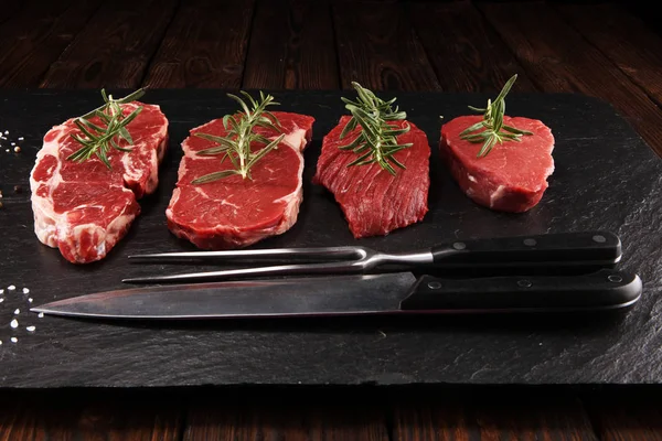 Steak raw. Barbecue Rib Eye Steak, dry Aged Wagyu Entrecote. Variety of Raw Black Angus Prime meat steaks Machete, Striploin, Rib eye, Tenderloin fillet mignon