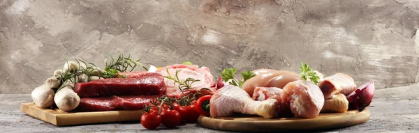 raw meat. Different types of raw pork meat, chicken and beef with spices and herbs and sausages